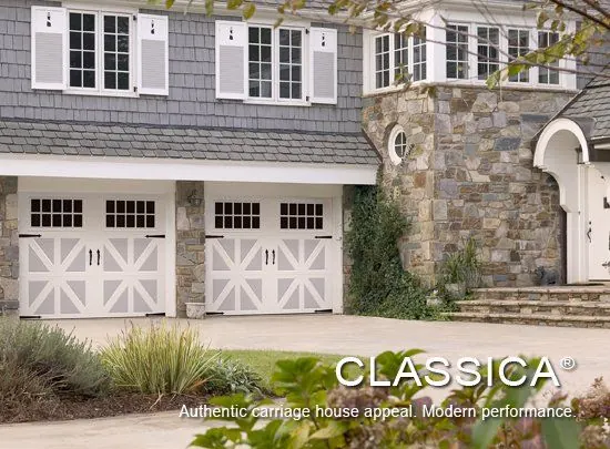 Amarr Classica carriage-style garage doors on a gray stone home