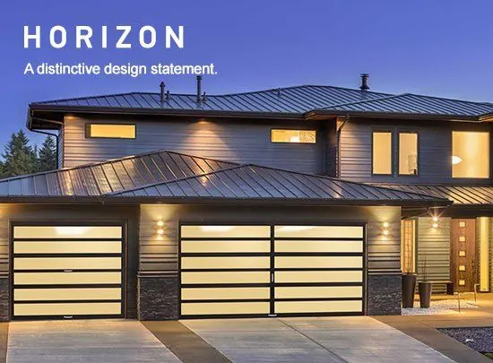 Amarr Horizon full-view glass garage doors on a modern home at dusk