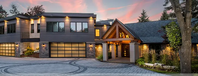 Contemporary glass and steel garage doors at dusk