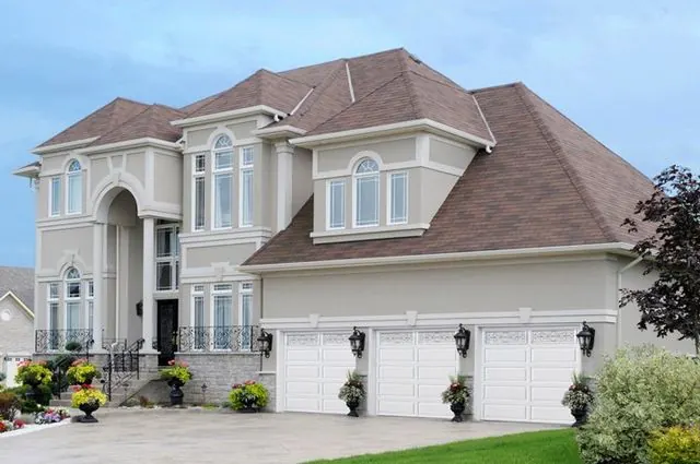 Raynor Masterpiece garage doors on a large stucco home