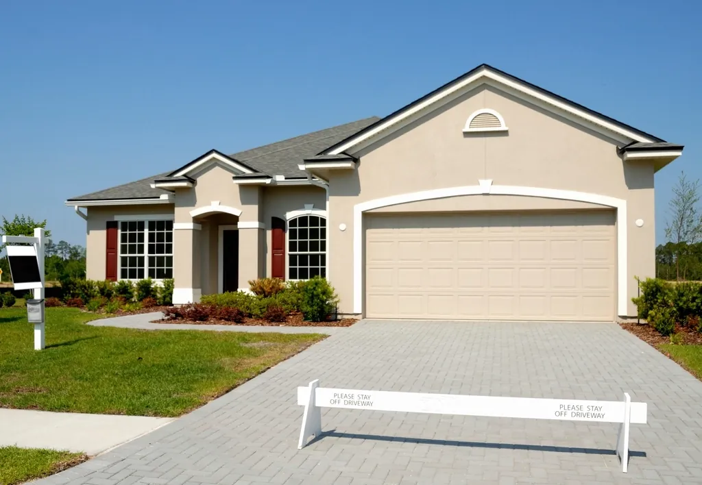 Suburban home with a tan two-car garage door